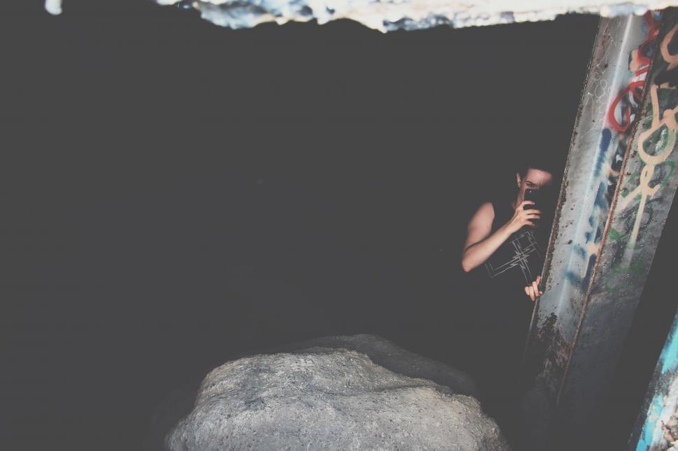 Free Image of Woman Climbing Up Graffiti-Covered Wall 