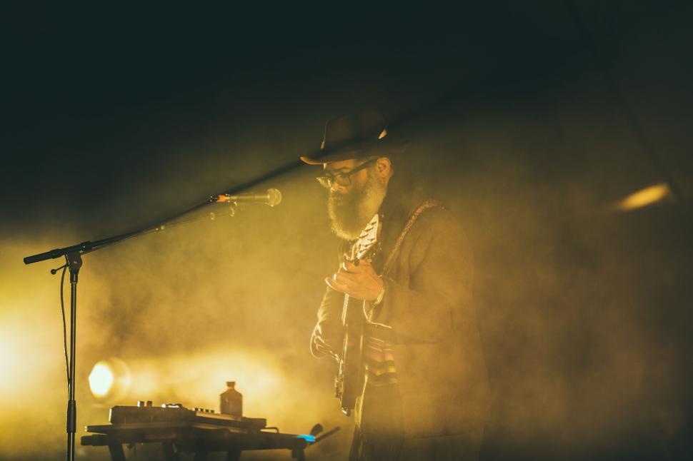 Free Image of Man Standing Next to Keyboard on Stage 