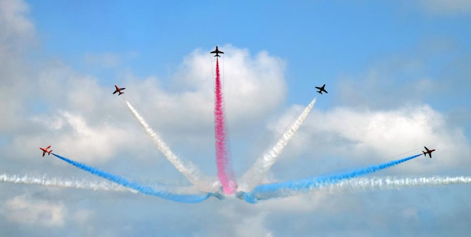 Free Image of Group of Airplanes Flying Through Cloudy Sky 