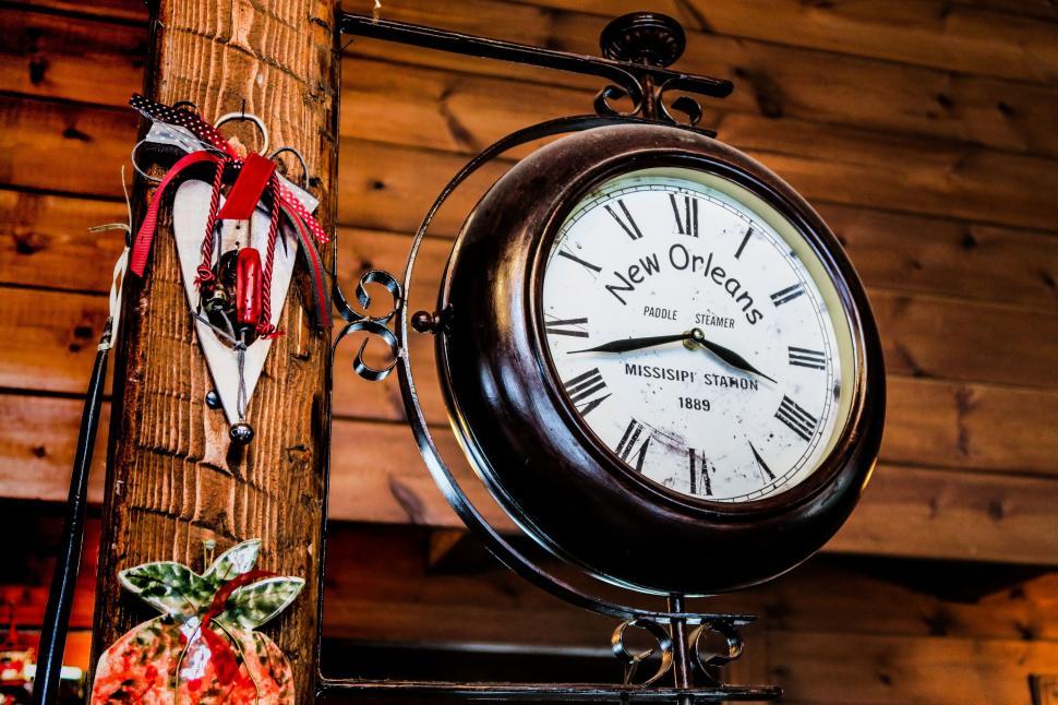 Free Image of Clock on a Pole Next to a Pair of Skis 