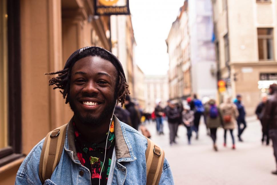 Free Image of Man With Dreadlocks Standing in Front of Building 