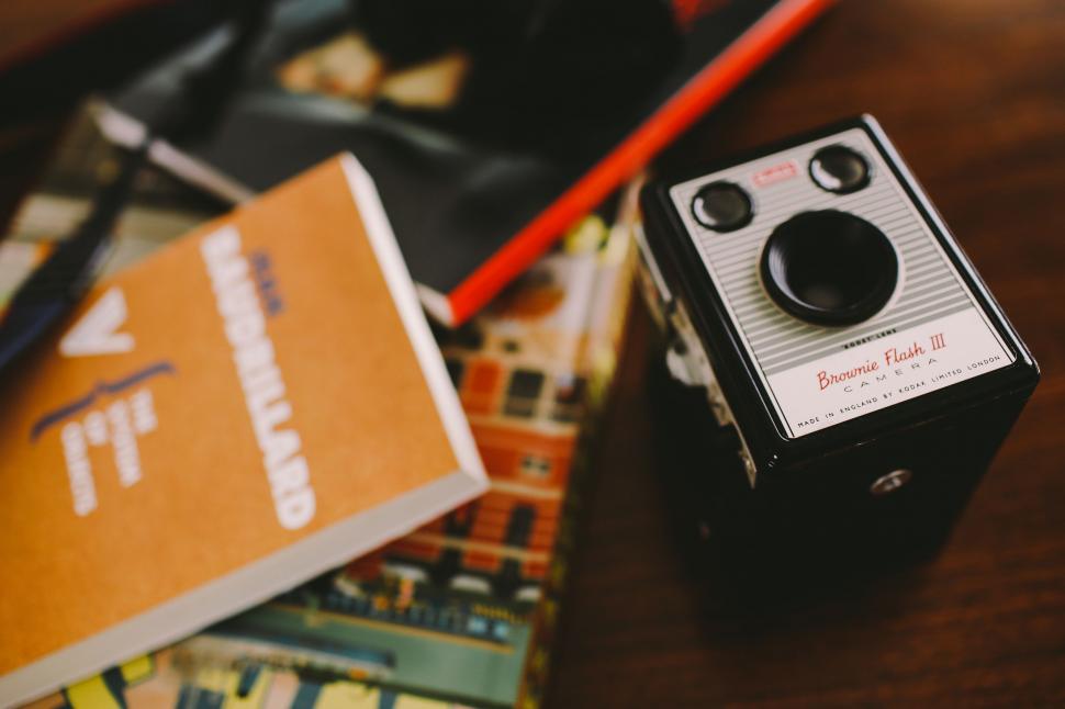 Free Image of Camera on Table Next to Book 