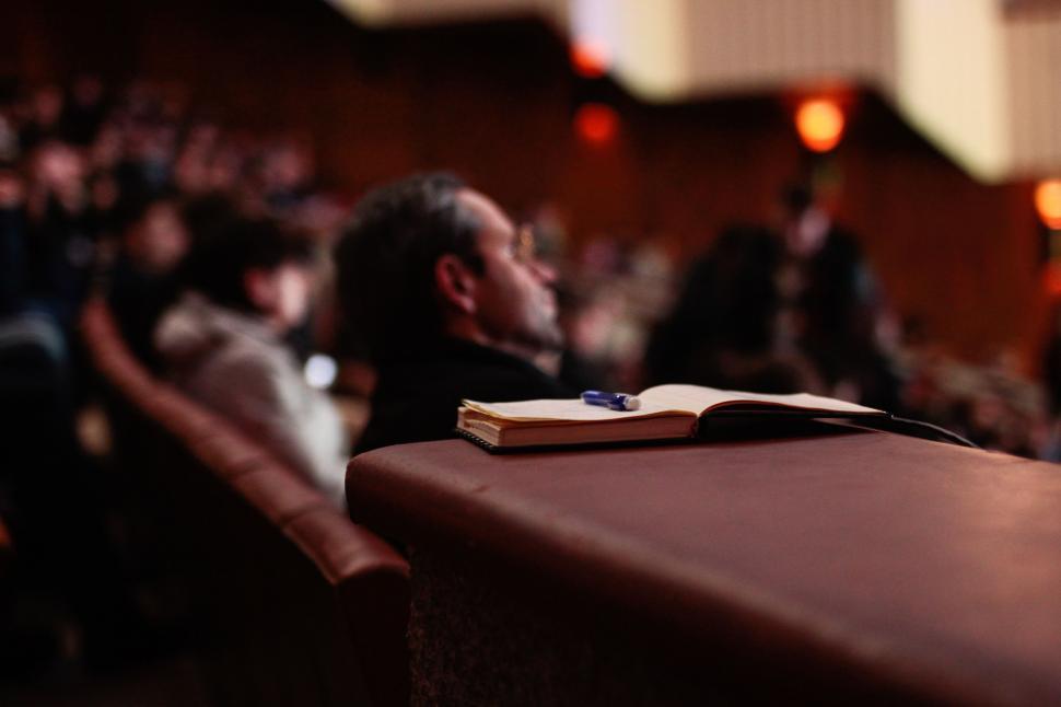 Free Image of Man Sitting at Table With Book 
