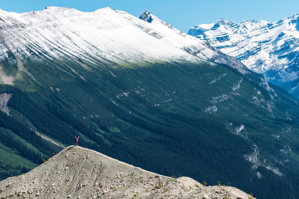 Free Image of Person Standing on Top of Snow-Covered Mountain 