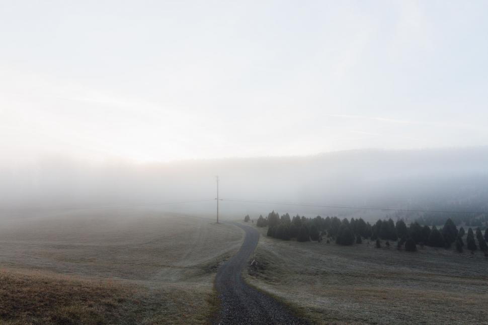 Free Image of A Black and White Photo of a Dirt Road 