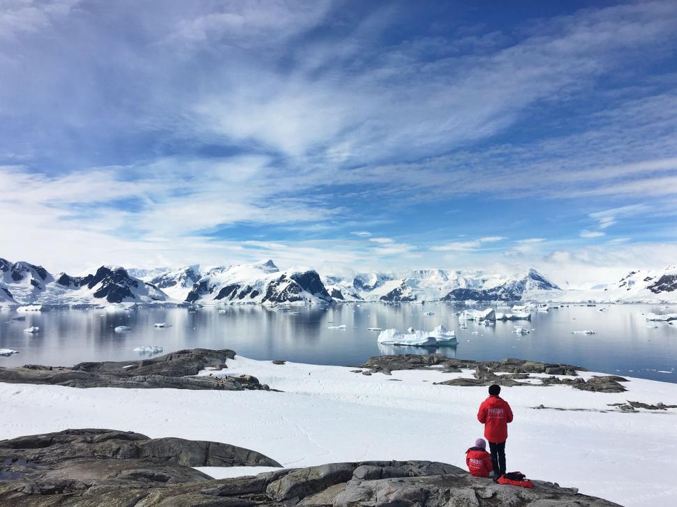 Free Image of Man Standing on Top of Snow-Covered Mountain 
