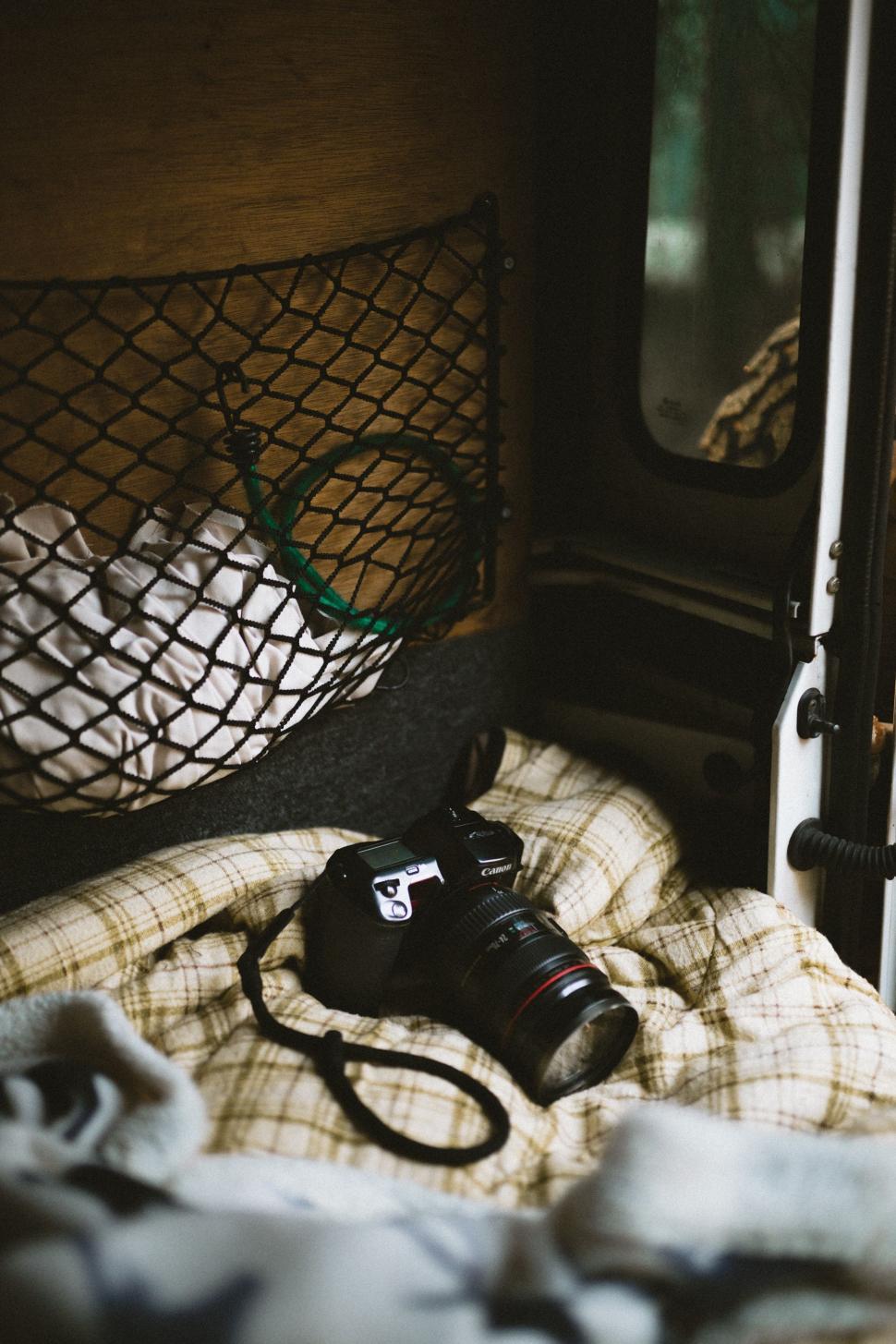 Free Image of Camera on Bed by Window 