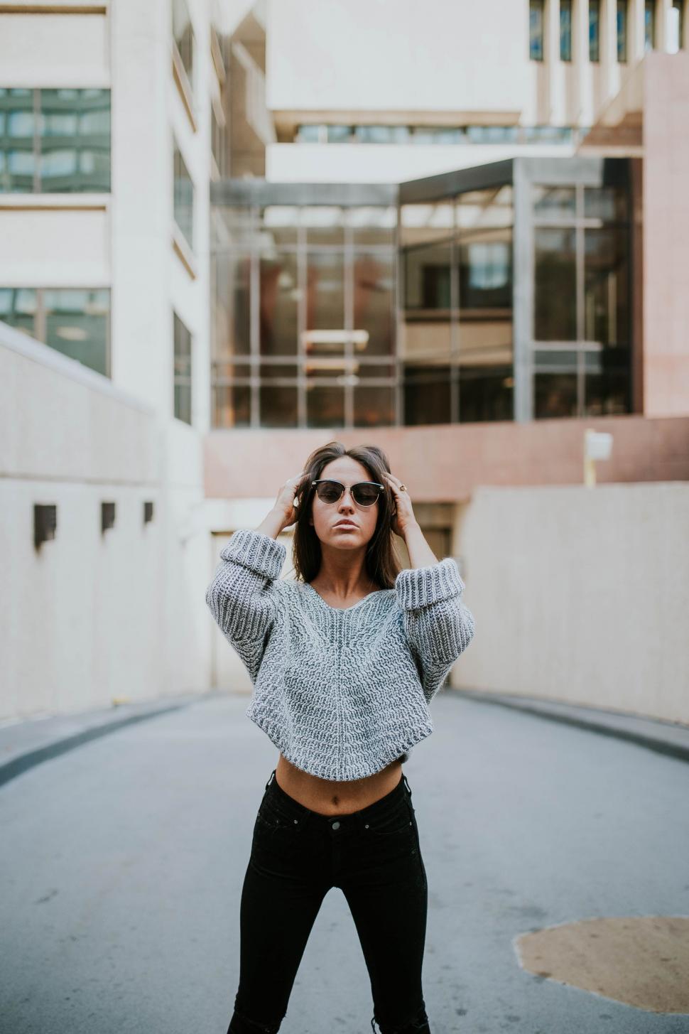Free Image of Woman Standing in the Middle of a Street 