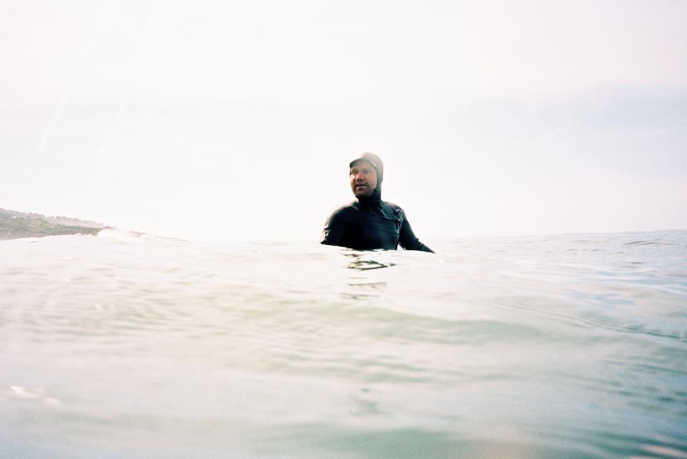 Free Image of Man Riding Surfboard on Wave in Ocean 