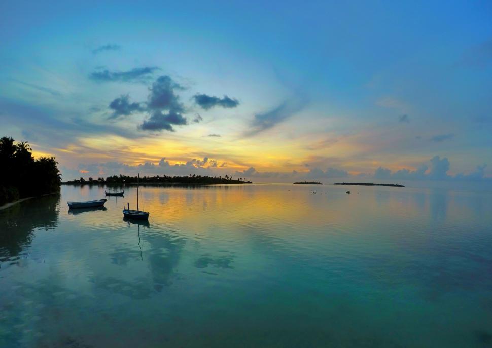 Free Image of Small Boat Floating on Large Body of Water 