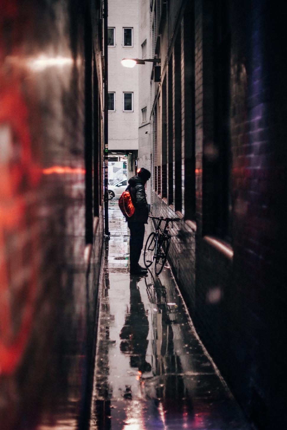 Free Image of Person Walking Down Hallway With Bike 