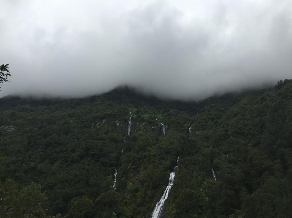Free Image of Majestic Waterfall Cascading Down a Rocky Cliff 