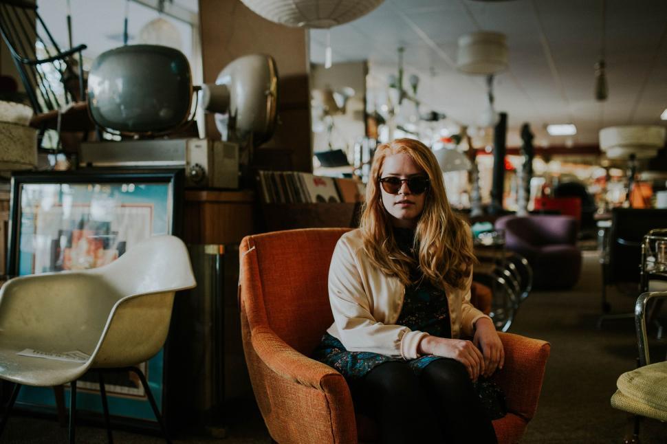 Free Image of Woman Sitting in Chair in Room 