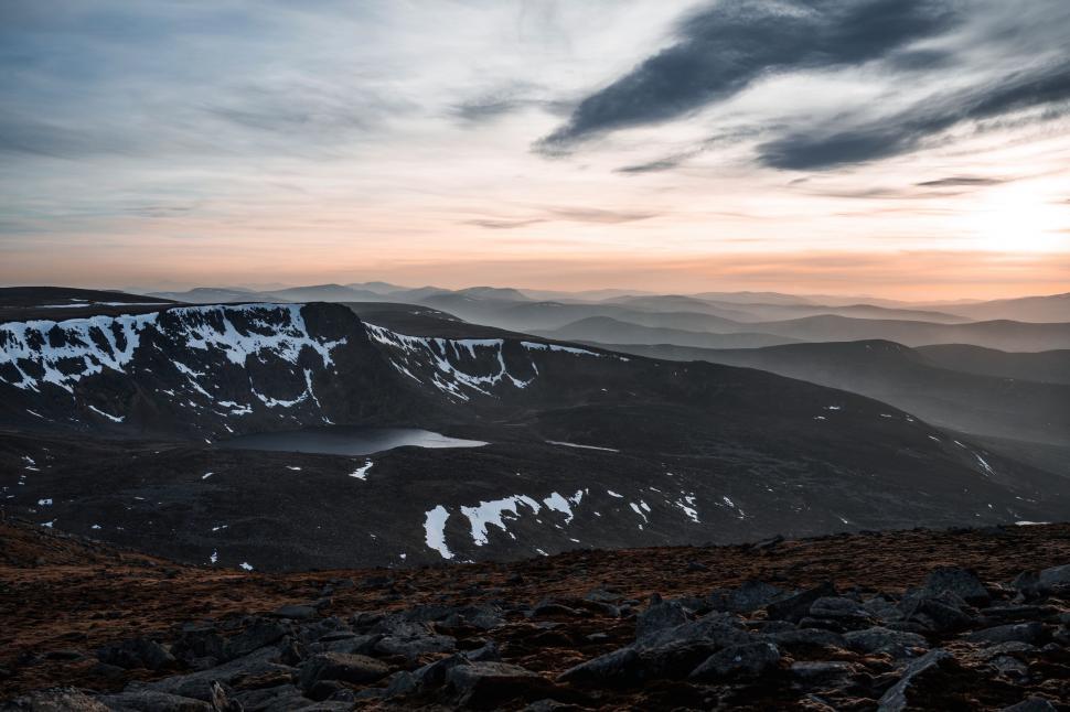 Free Image of Majestic Mountain Range Silhouetted Against Stunning Sunset 
