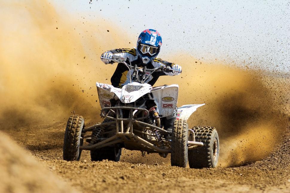 Free Image of Man Riding White Four-Wheeler on Dirt 