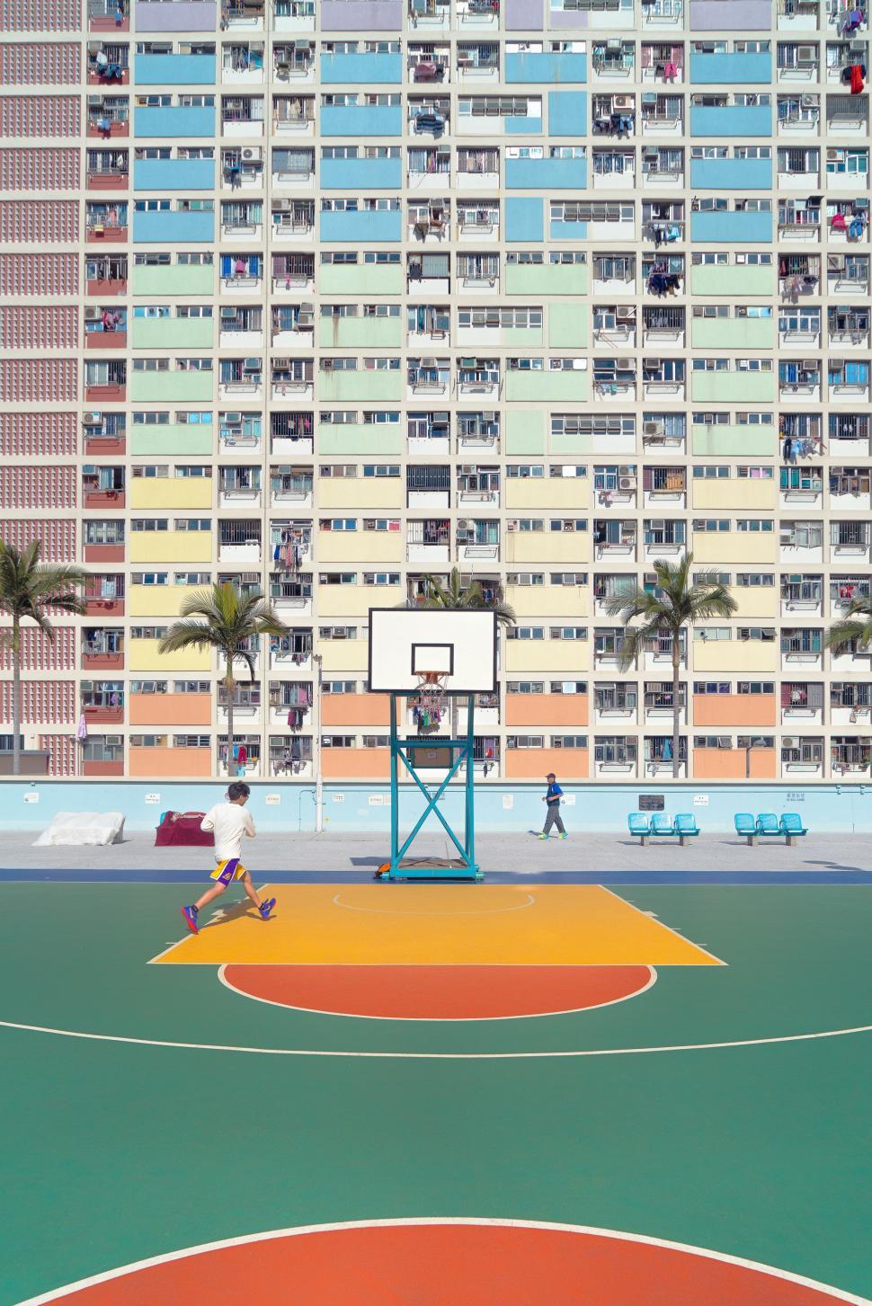 Free Image of Basketball Court in Front of Tall Building 