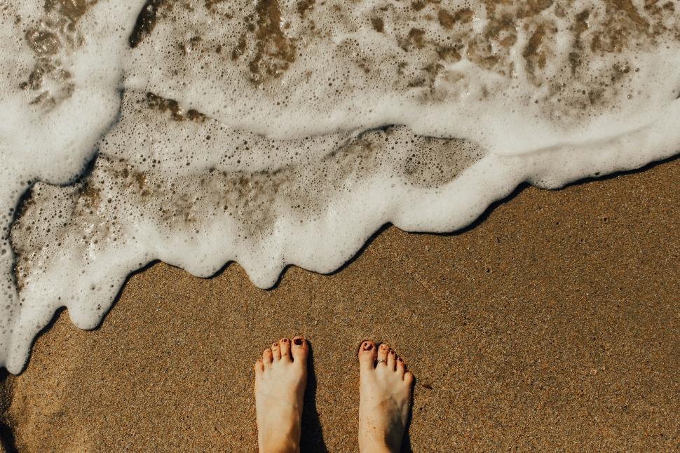 Free Image of Person Standing on Beach Next to Ocean 