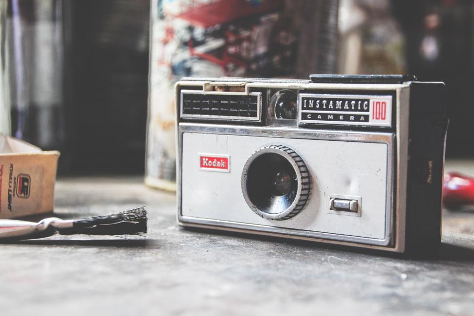 Free Image of Old Fashioned Camera Next to Brush 