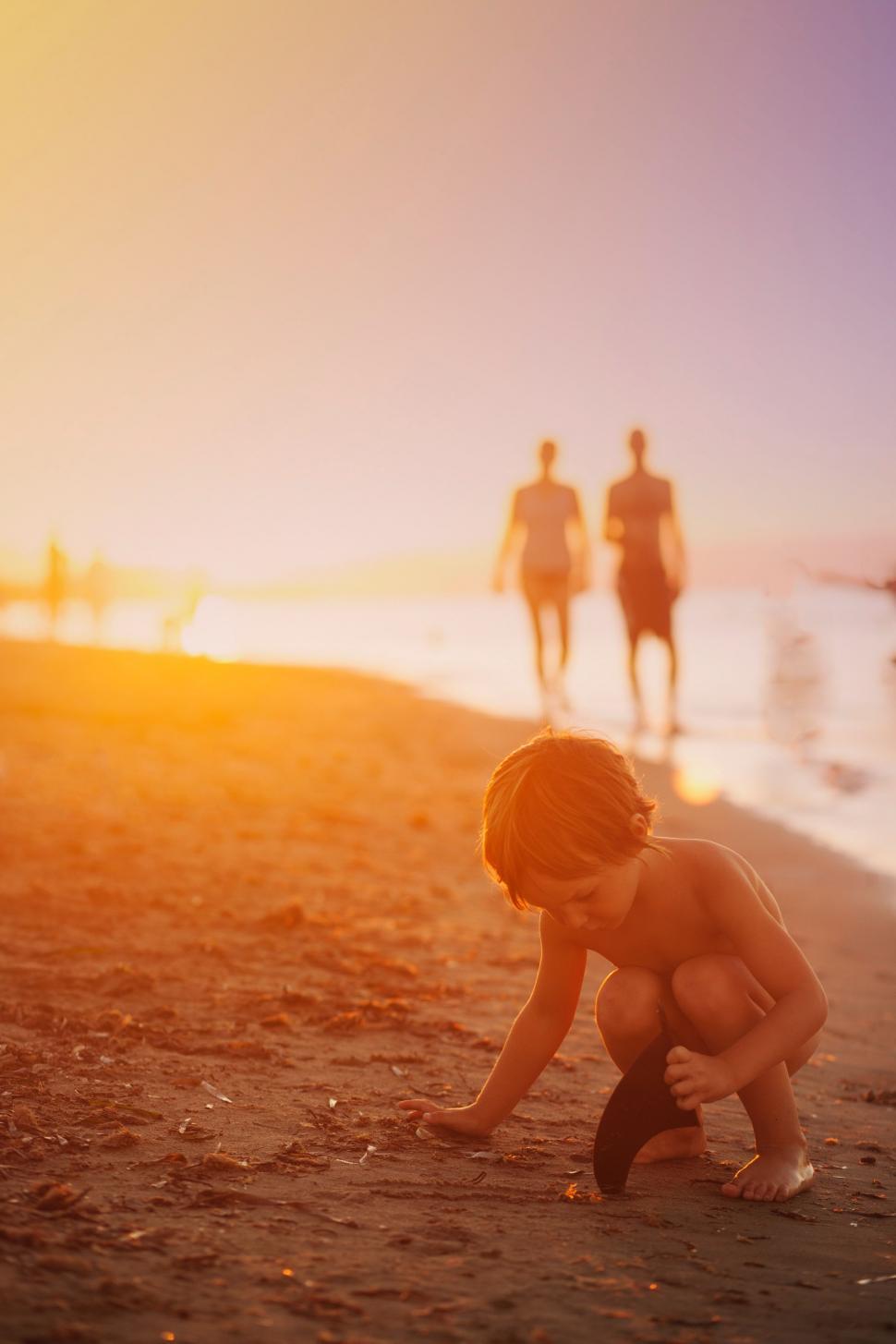 Free Image of Young Boy Playing With Frisbee on Beach 