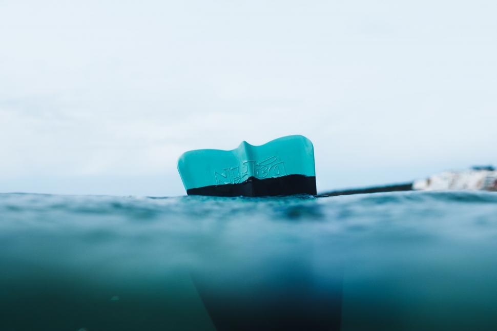 Free Image of Small Boat Floating in Ocean With Sky Background 