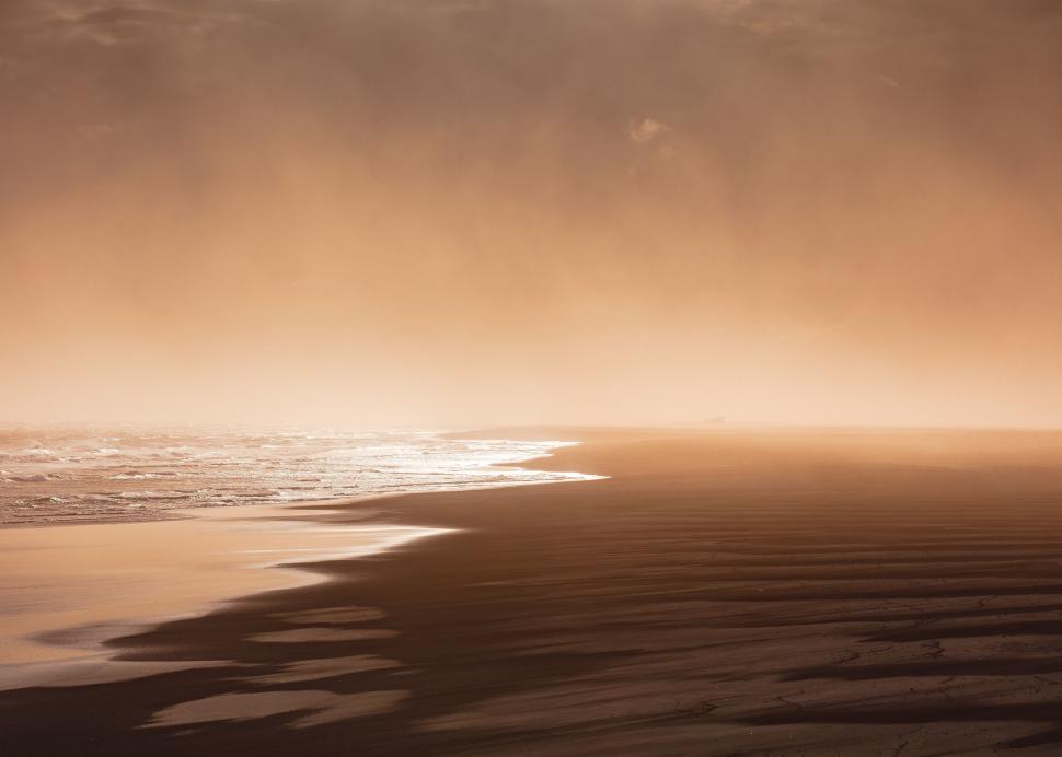 Free Image of Person Walking on Beach With Surfboard 