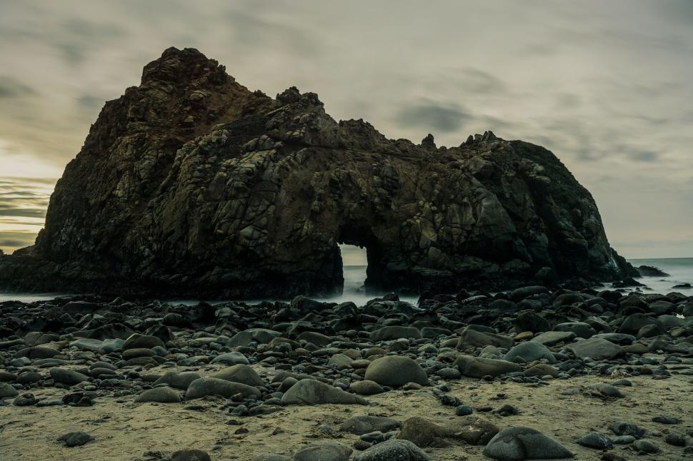 Free Image of Rock Formation on Beach With Body of Water 