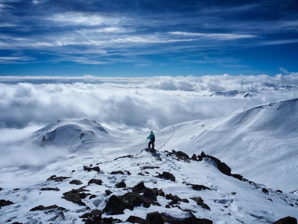 Free Image of Man Standing on Top of Snow Covered Mountain 