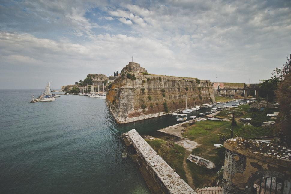 Free Image of Large Body of Water Next to Stone Wall 