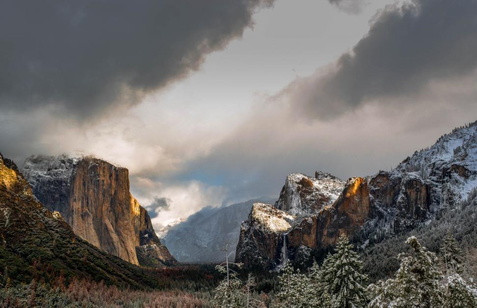 Free Image of Snow-Covered Mountains Blanketed by Clouds 