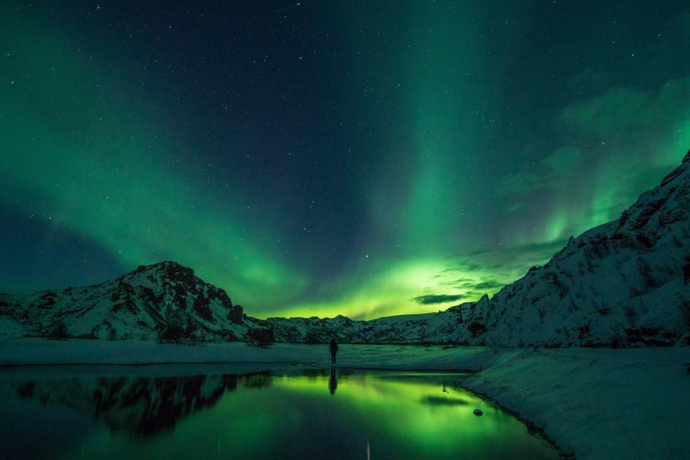 Free Image of Person Standing in Snow Under Green Light 