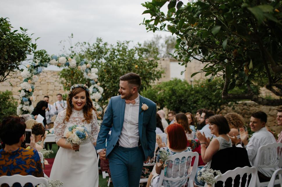 Free Image of Bride and Groom Walking Down the Aisle 
