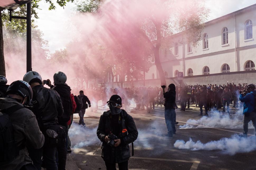 Free Image of Group of People Standing Around Smoke 