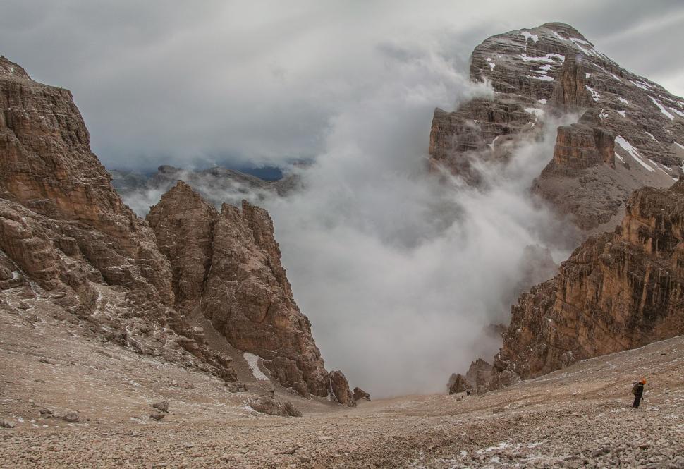 Free Image of Man Climbing Mountain With Smoke Cloud 