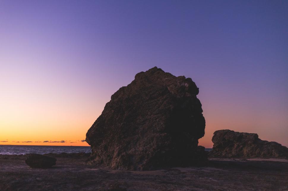 Free Image of Large Rock on Sandy Beach 