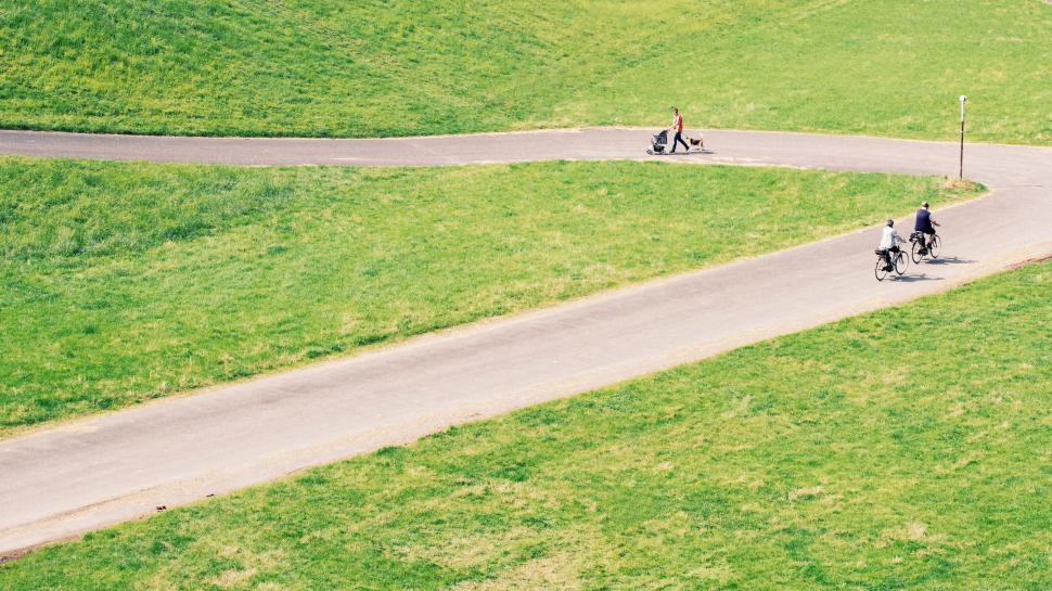 Free Image of Group of People Riding Motorcycles Down a Curvy Road 