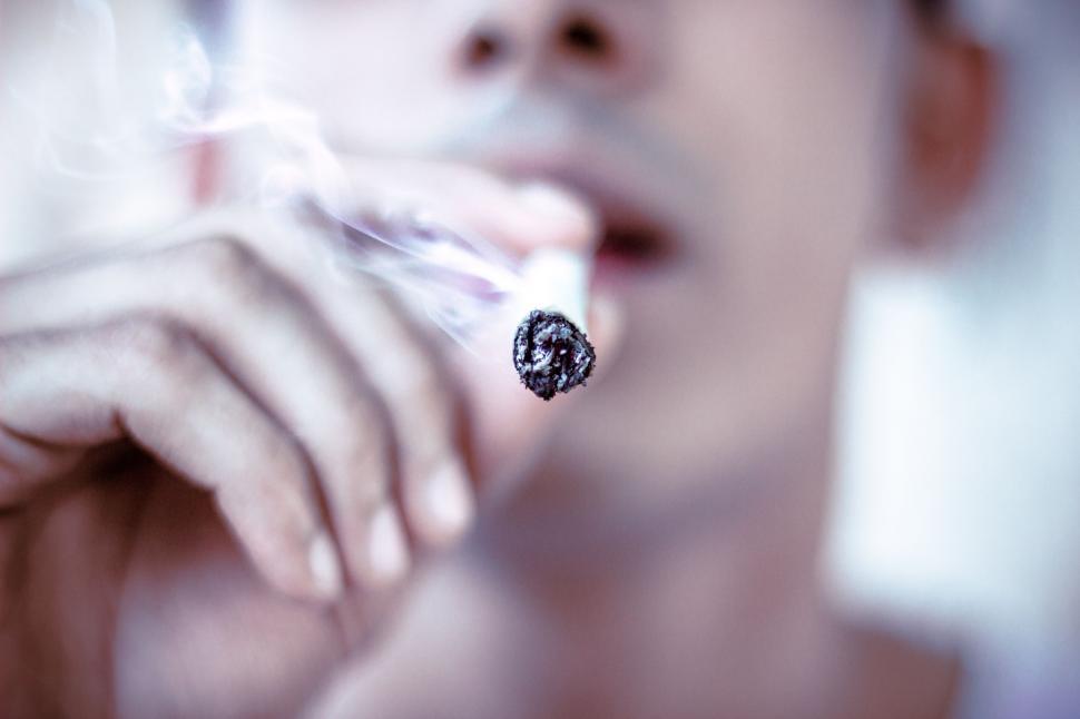 Free Image of Woman Holding Cigarette in Hand 