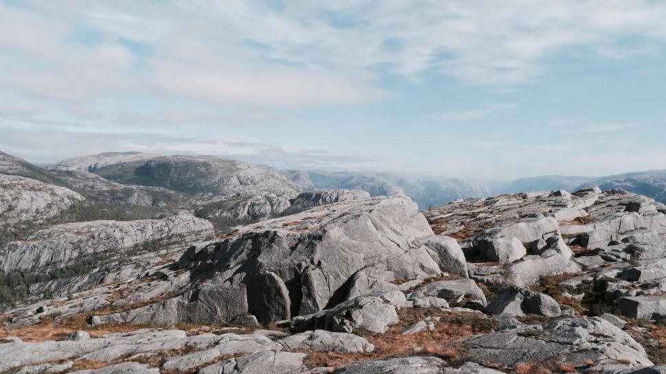 Free Image of Man Standing on Top of Rocky Mountain 