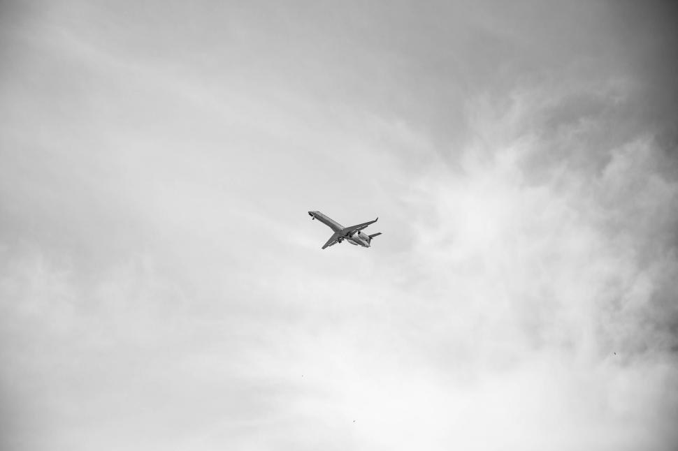 Free Image of Airplane Flying Through Cloudy Sky 