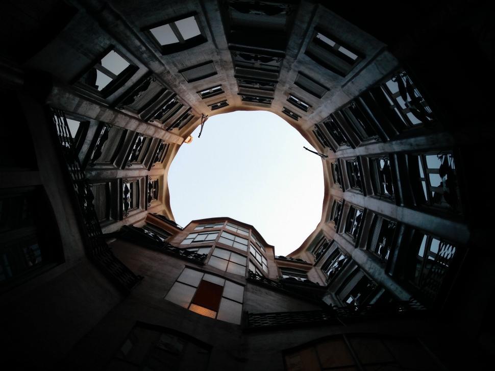 Free Image of Looking Up at Sky Through Circular Hole in Building 