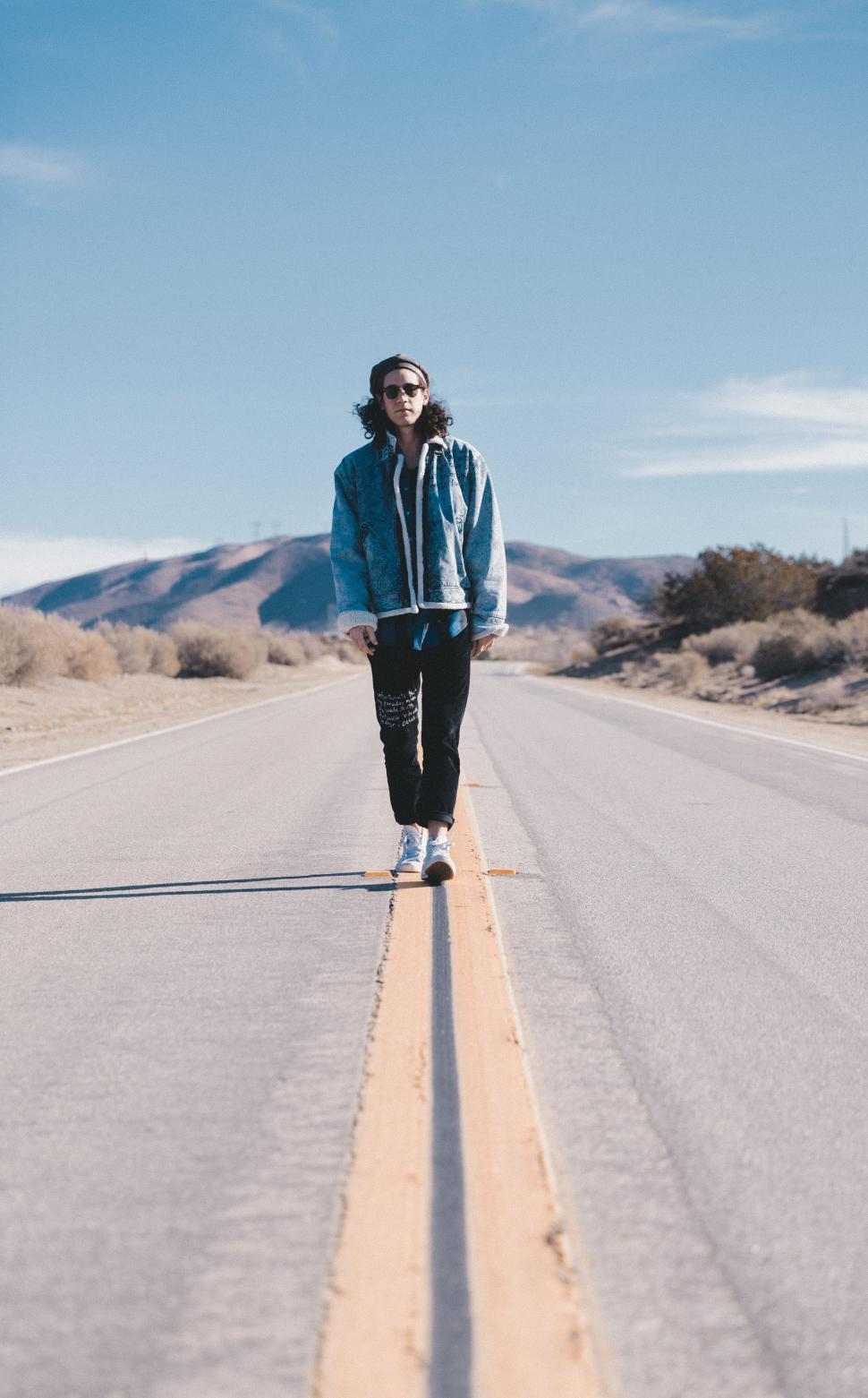 Free Image of Person Standing on Side of Road 