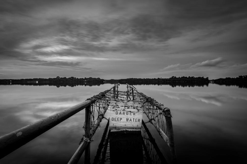 Free Image of Boat Floating on Lake Under Cloudy Sky 