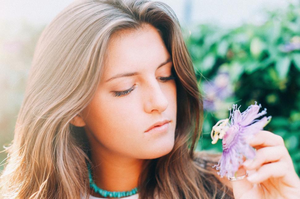 Free Image of Woman Holding Flower in Right Hand 