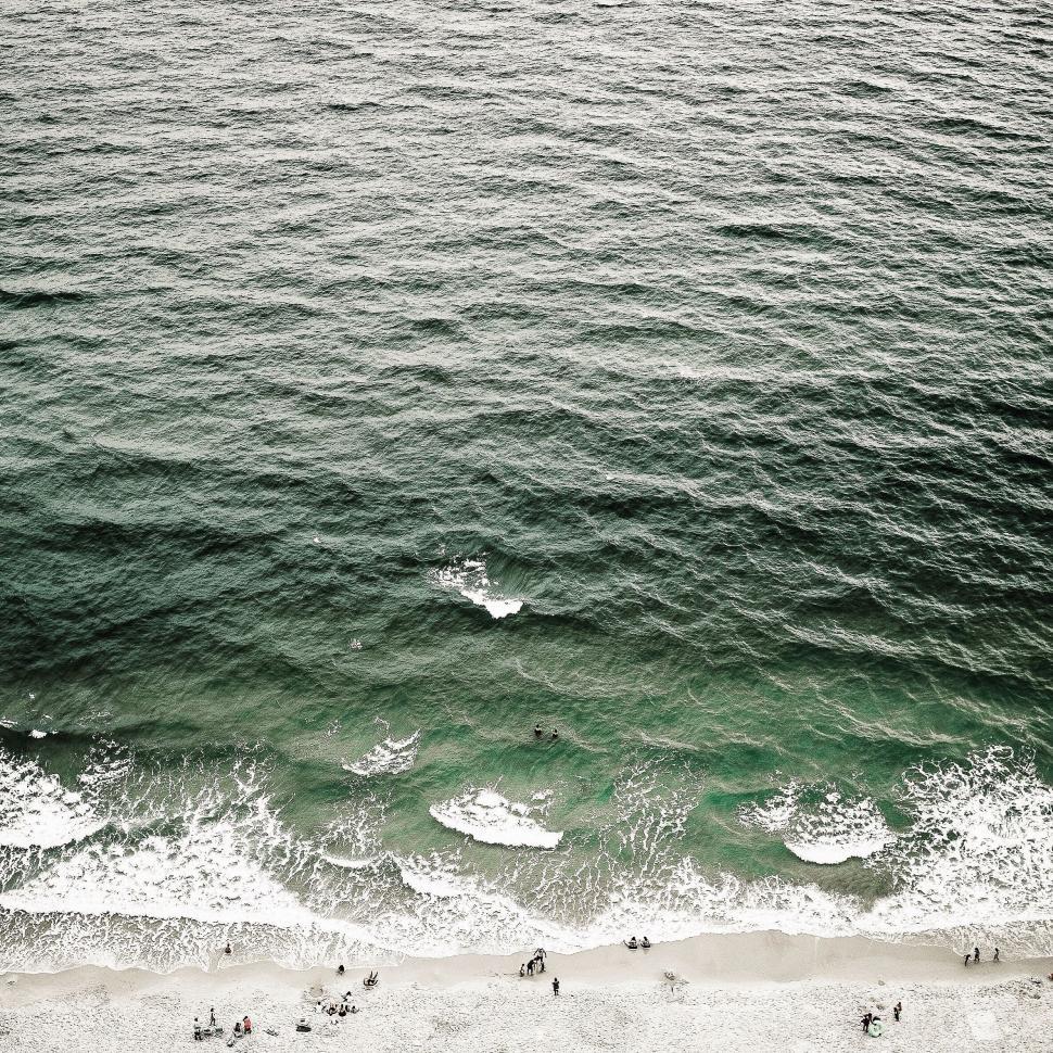Free Image of People Walking on Beach 