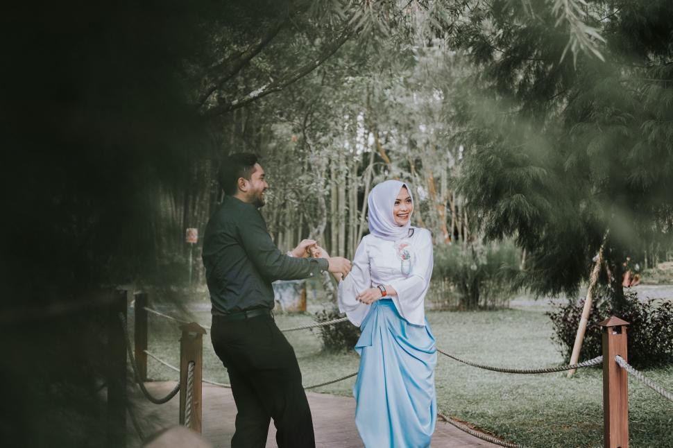 Free Image of Man Standing Next to Woman in Blue Dress 