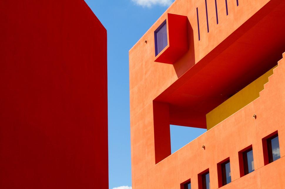Free Image of Red Stop Sign Next to Tall Building 