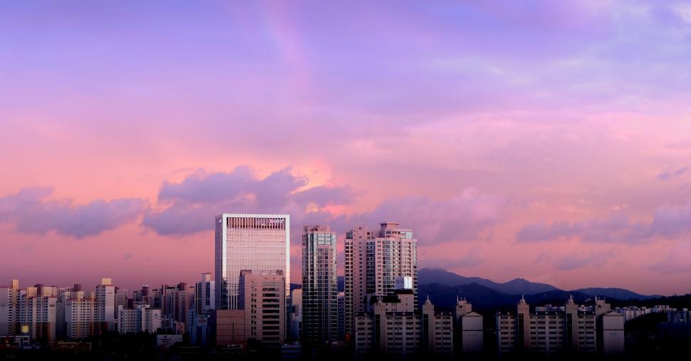 Free Image of Cityscape With Tall Buildings and Mountains 