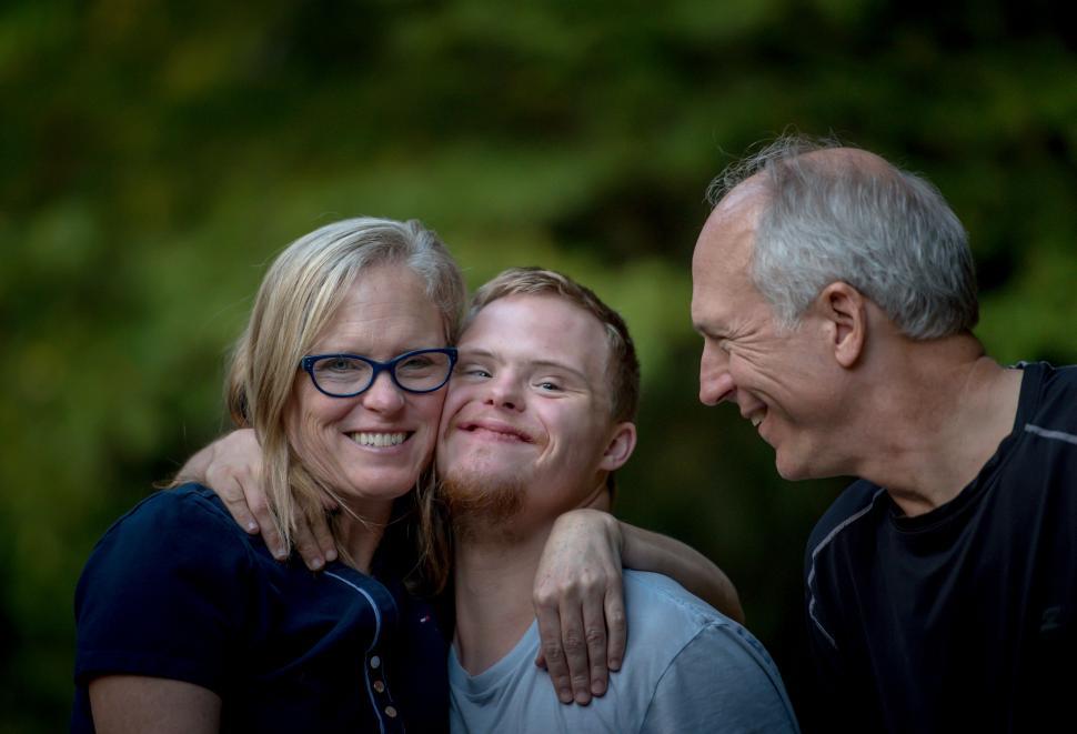 Free Image of Man and Two Women Hugging Each Other 