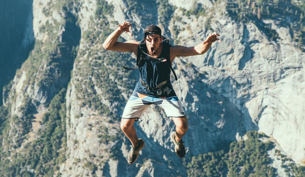 Free Image of Man in Black Shirt and White Shorts Jumping in the Air 
