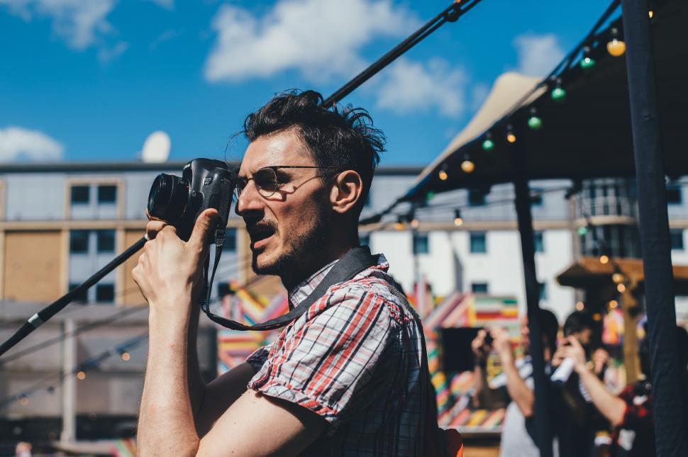 Free Image of Man Holding Camera Up to Face 