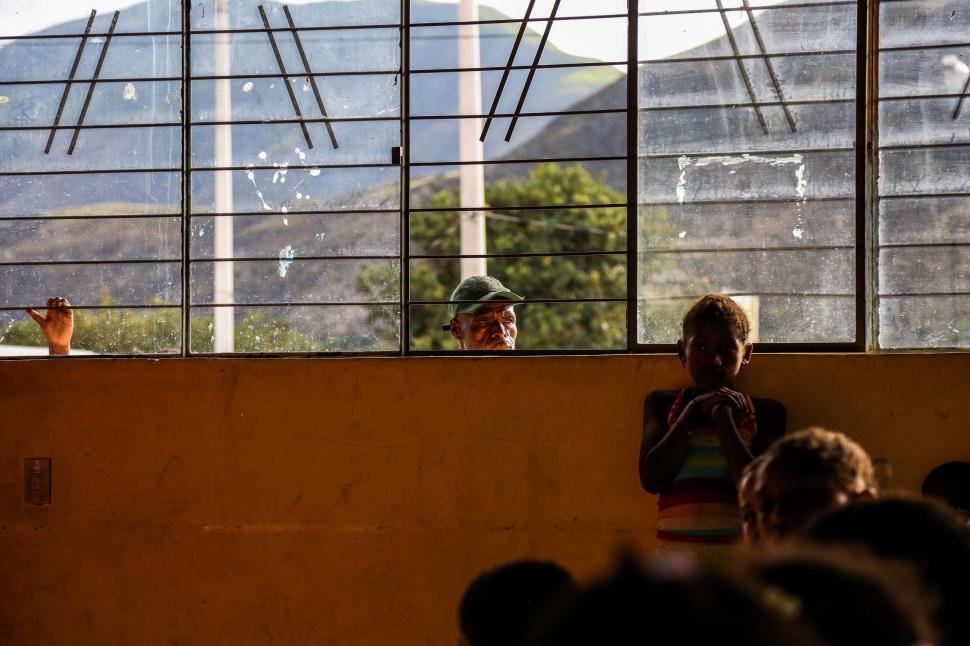 Free Image of Group of People Sitting in Front of a Window 